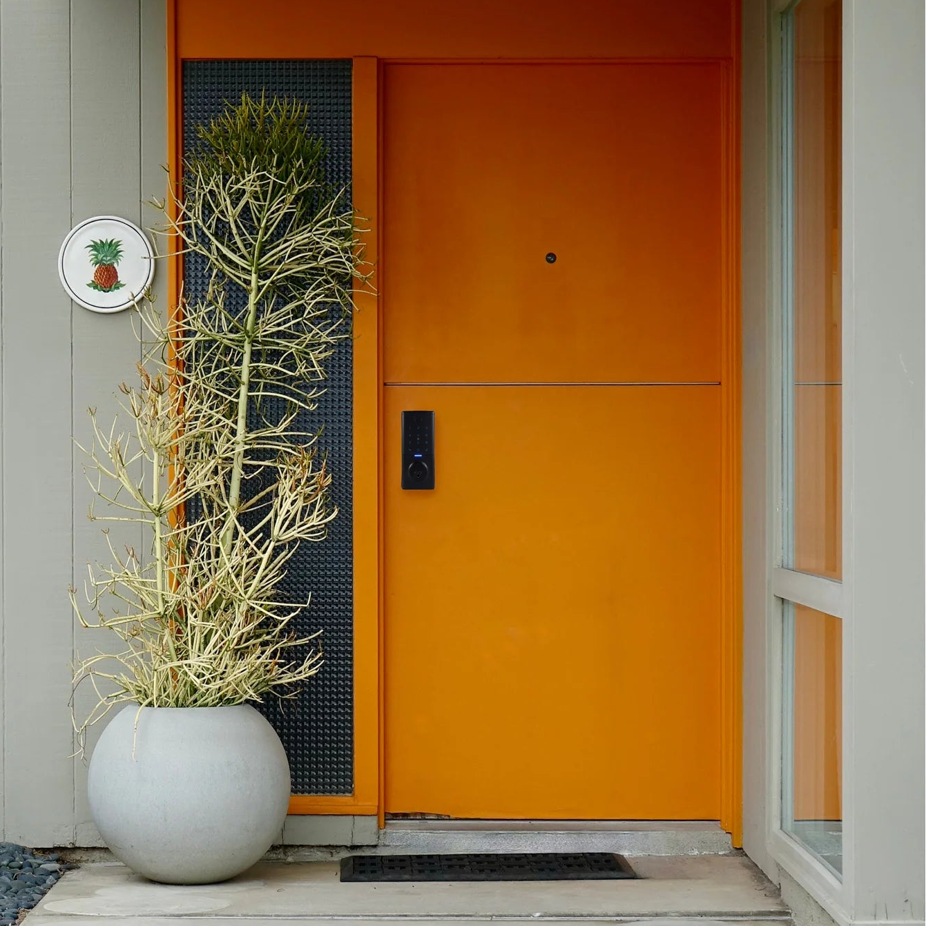 Gainsborough Mode Smart Lever Lock in black installed on a residential entrance door, showcasing its sleek low-profile design and bold black finish that complements both contemporary and classic architectural styles.