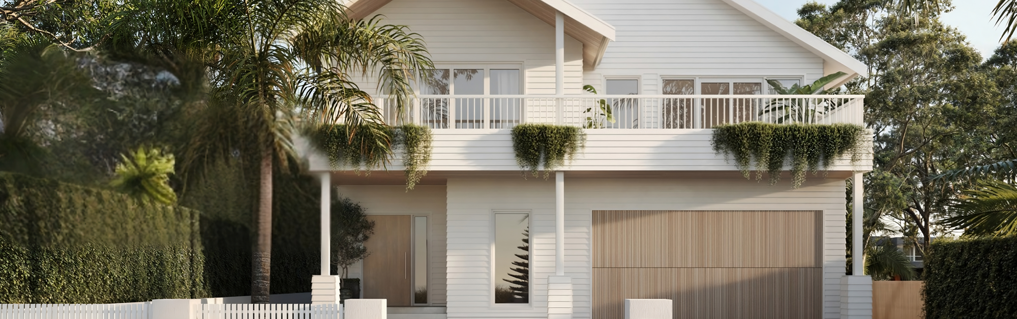 Two-story house with James Hardie cladding, surrounded by trees and shrubs.